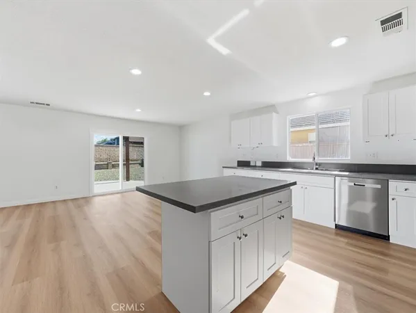 a spacious bathroom with a granite countertop sink a tub and a window