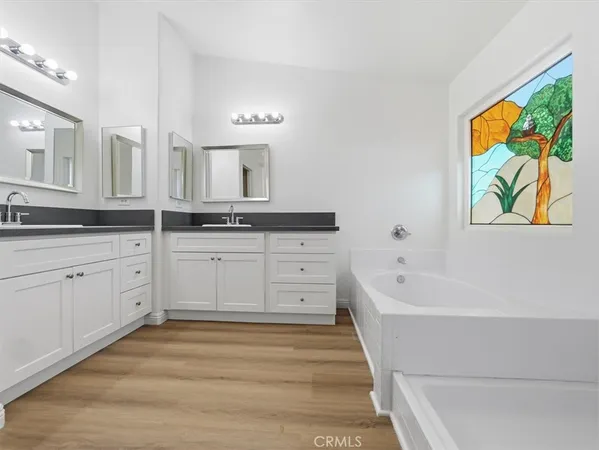 a kitchen with granite countertop a refrigerator and a stove top oven