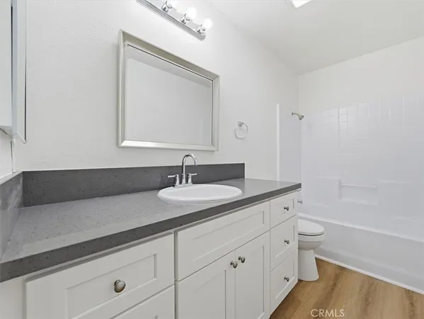 a white toilet sitting next to a white sink