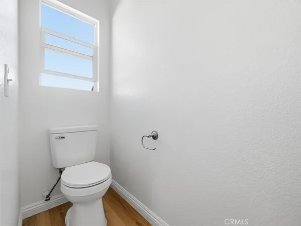 a white toilet sitting next to a bath tub