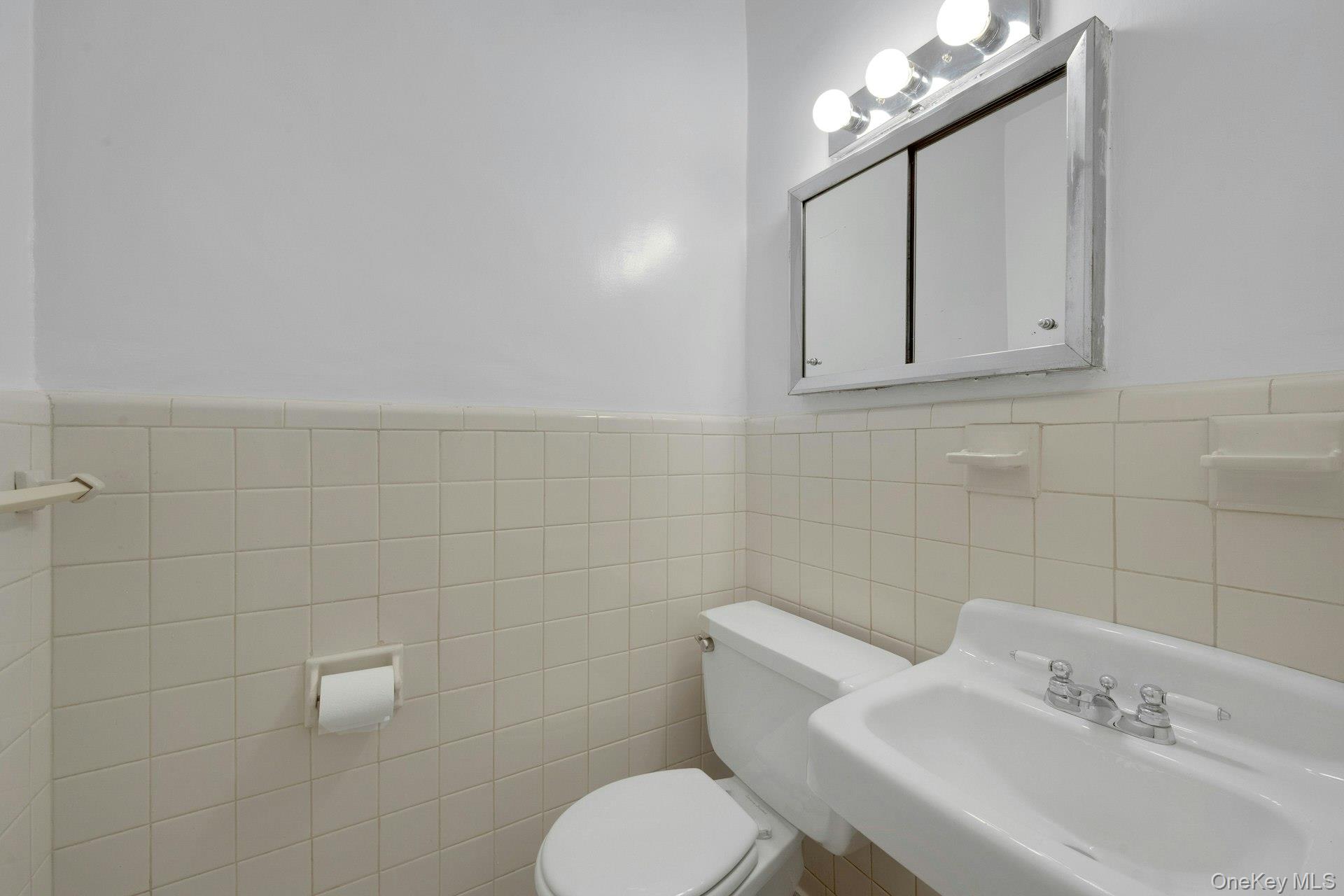 260 Garth Road, Unit 4E4 Scarsdale, NY 10583 - Photo 14 of 29 Bathroom with a wainscoted wall and tile walls