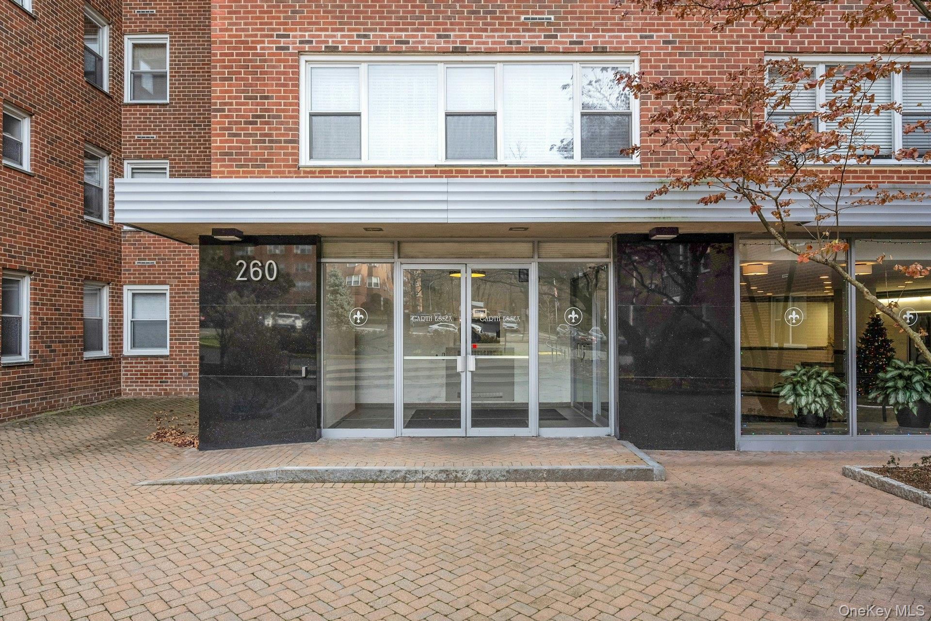260 Garth Road, Unit 4E4 Scarsdale, NY 10583 - Photo 3 of 29 View of exterior entry with brick siding