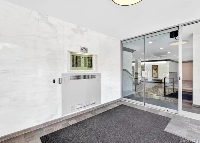 a large white kitchen with kitchen island a stove a sink cabinets and living room view