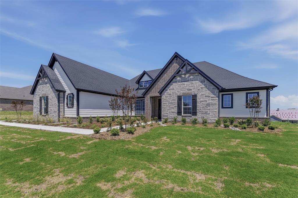 815 Vly Rdg Road Van Alstyne, TX 75495 - Photo 4 of 29 Single-story residence featuring a stone and siding facade with dark trim accents