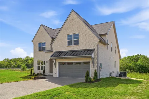 a view of house with yard and entertaining space