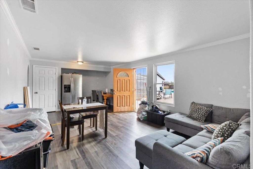 735 Osage Street Spring Valley, CA 91977 - Photo 15 of 25 a living room with furniture and a wooden floor
