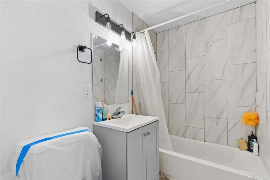 735 Osage Street Spring Valley, CA 91977 - Photo 16 of 25 a bathroom with a sink and a bathtub