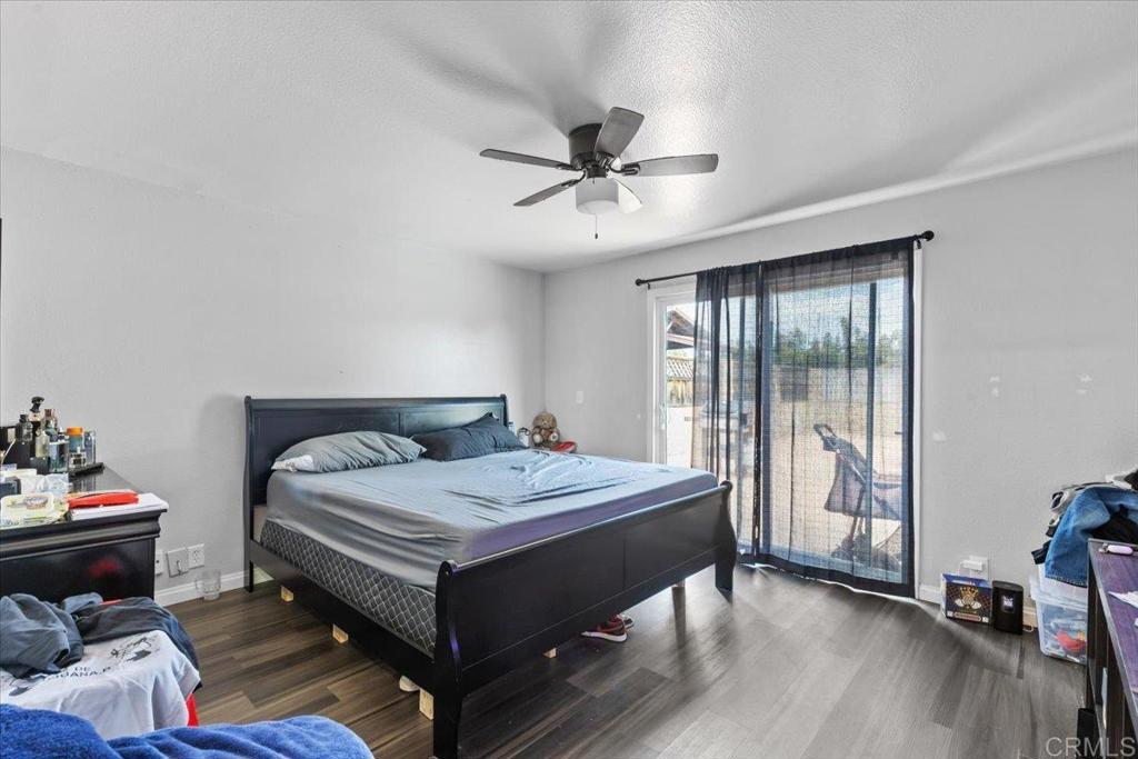 735 Osage Street Spring Valley, CA 91977 - Photo 17 of 25 a bedroom with a bed and a chandelier