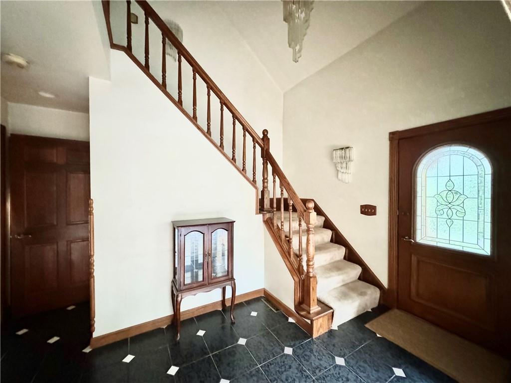 796 Hoover Road New Castle, PA 16101 - Photo 12 of 43 a view of staircase with lots of frames and frames on wall