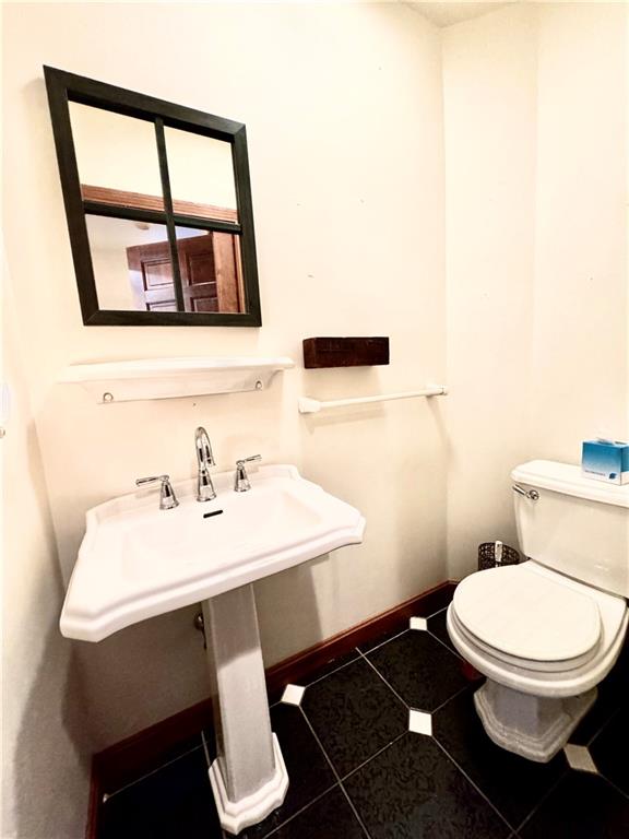 796 Hoover Road New Castle, PA 16101 - Photo 25 of 43 a bathroom with a sink a toilet and a mirror