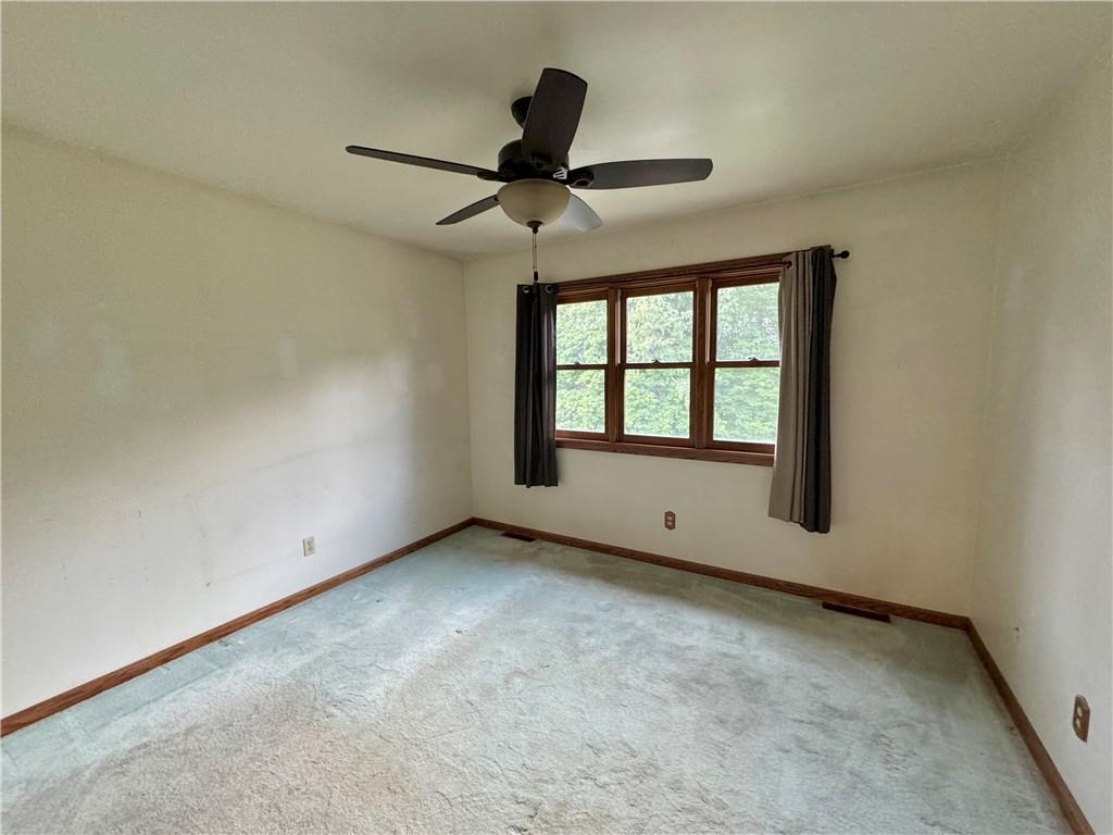 796 Hoover Road New Castle, PA 16101 - Photo 33 of 43 an empty room with ceiling fan and windows