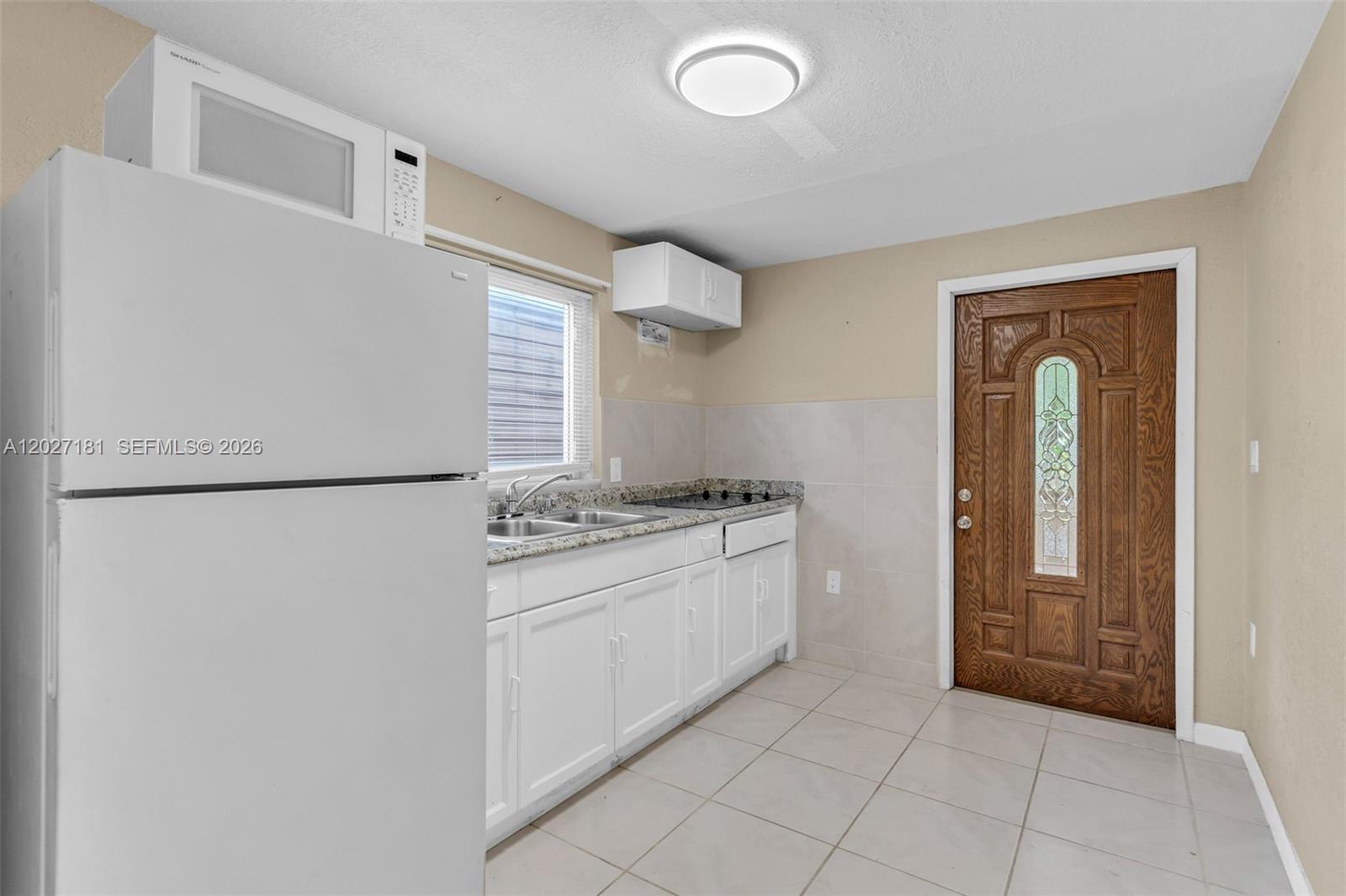 15440 Southwest 294th Terrace Homestead, FL 33033 - Photo 17 of 31 a kitchen with a refrigerator stove and sink