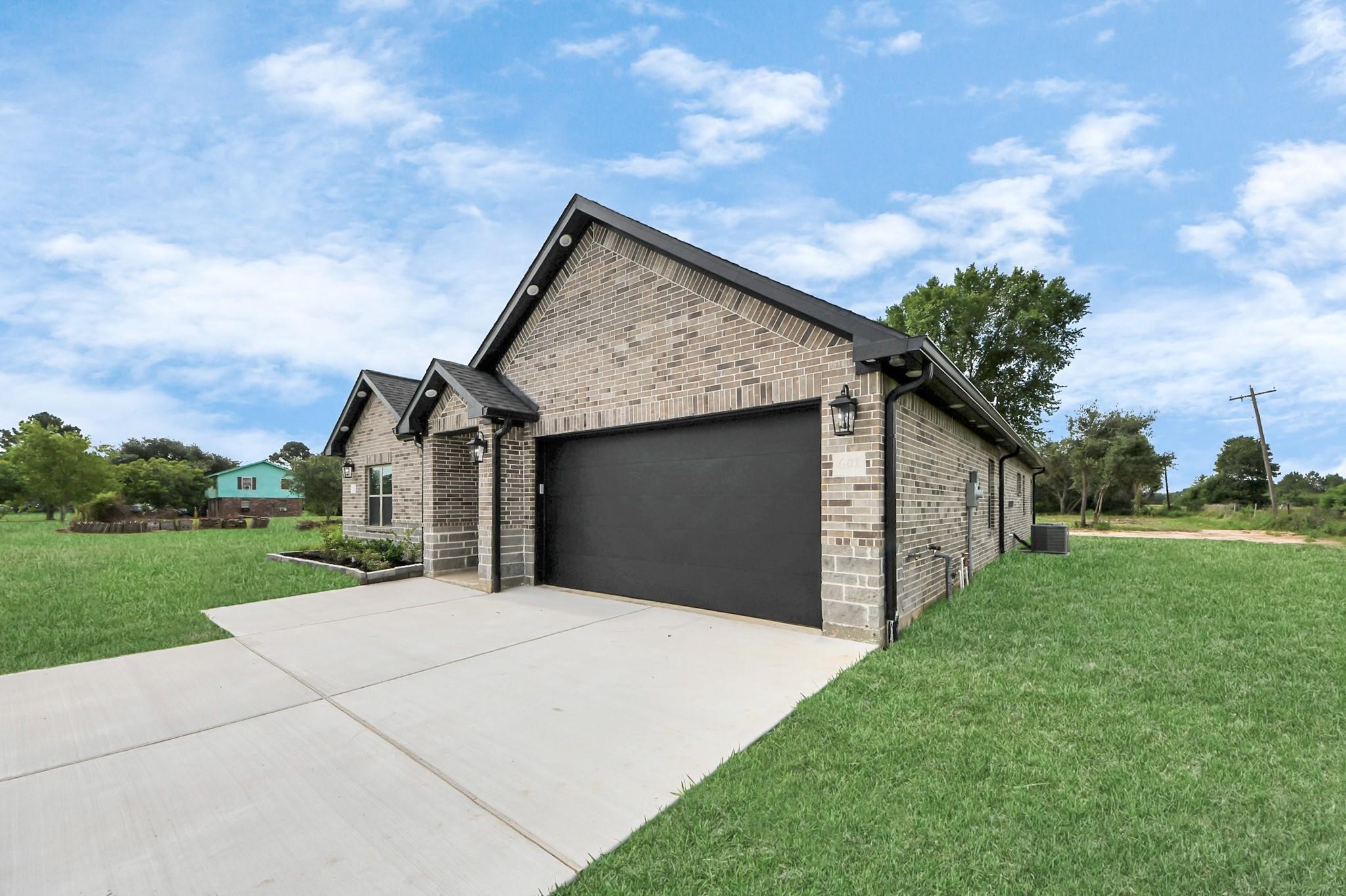 601 Lily Street Prairie View, TX 77484 - Photo 3 of 14 a front view of a house with a yard and garage