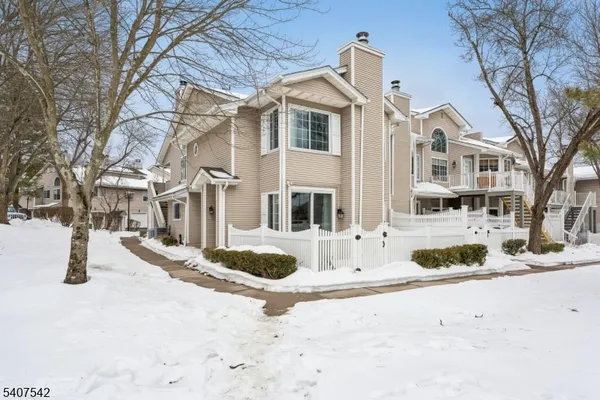 a view of a building with snow on the road