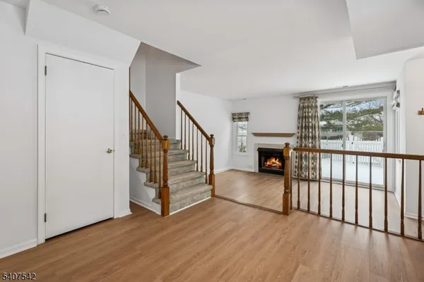 a view of a livingroom with wooden floor and stairs