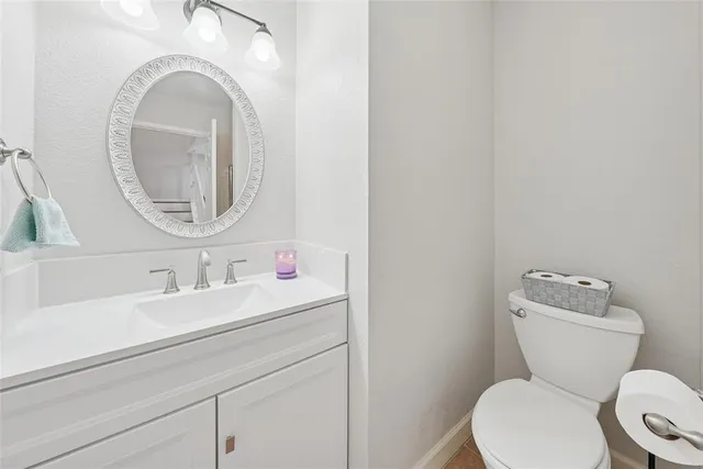 a bathroom with a toilet a sink and a mirror