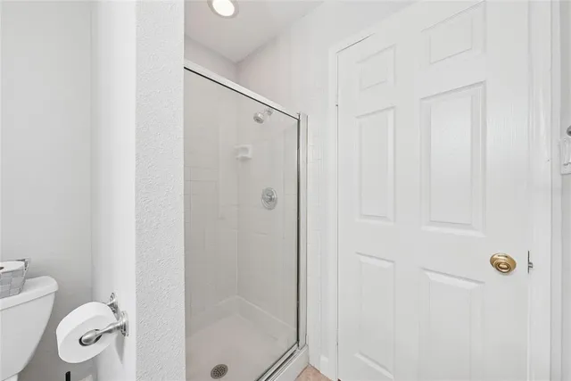 a bathroom with a shower and a toilet