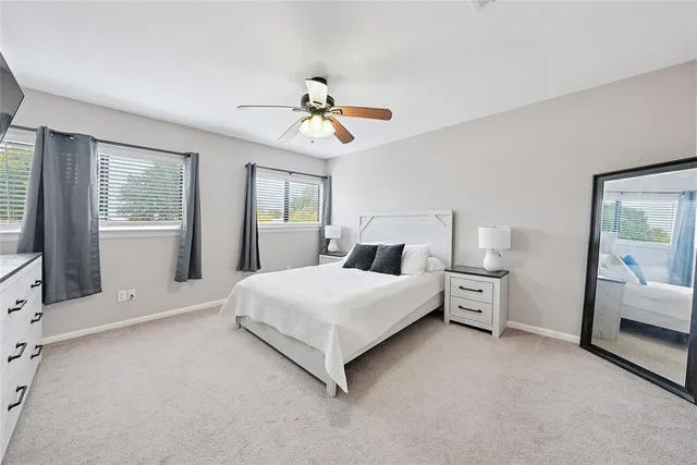 a spacious bedroom with a bed and a chandelier