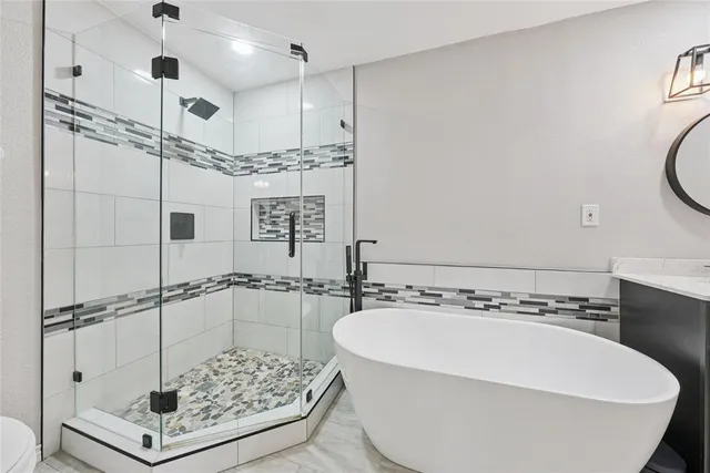 a bathroom with a bathtub and shower