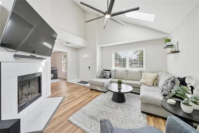 a living room with furniture a fireplace and a flat screen tv