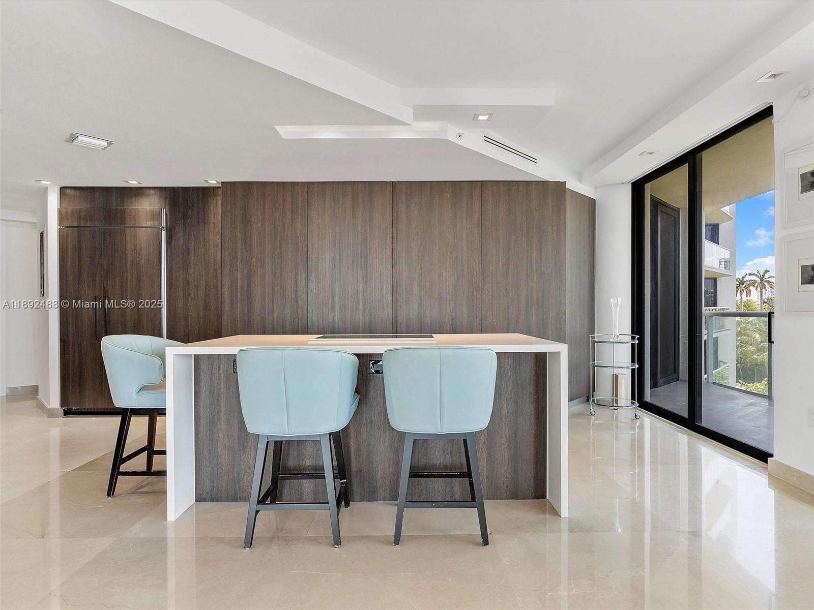 4000 Island Boulevard, Unit 606 Aventura, FL 33160 - Photo 12 of 36 a view of a dining room with a table and chairs