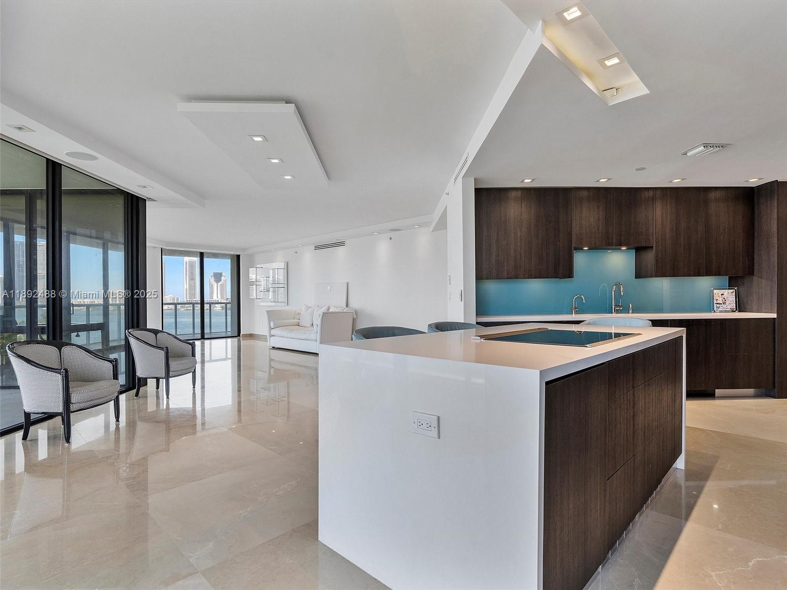 4000 Island Boulevard, Unit 606 Aventura, FL 33160 - Photo 14 of 36 a kitchen with counter top space and living room