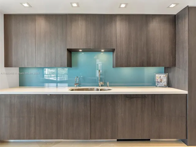 a kitchen with a sink a cabinets and window