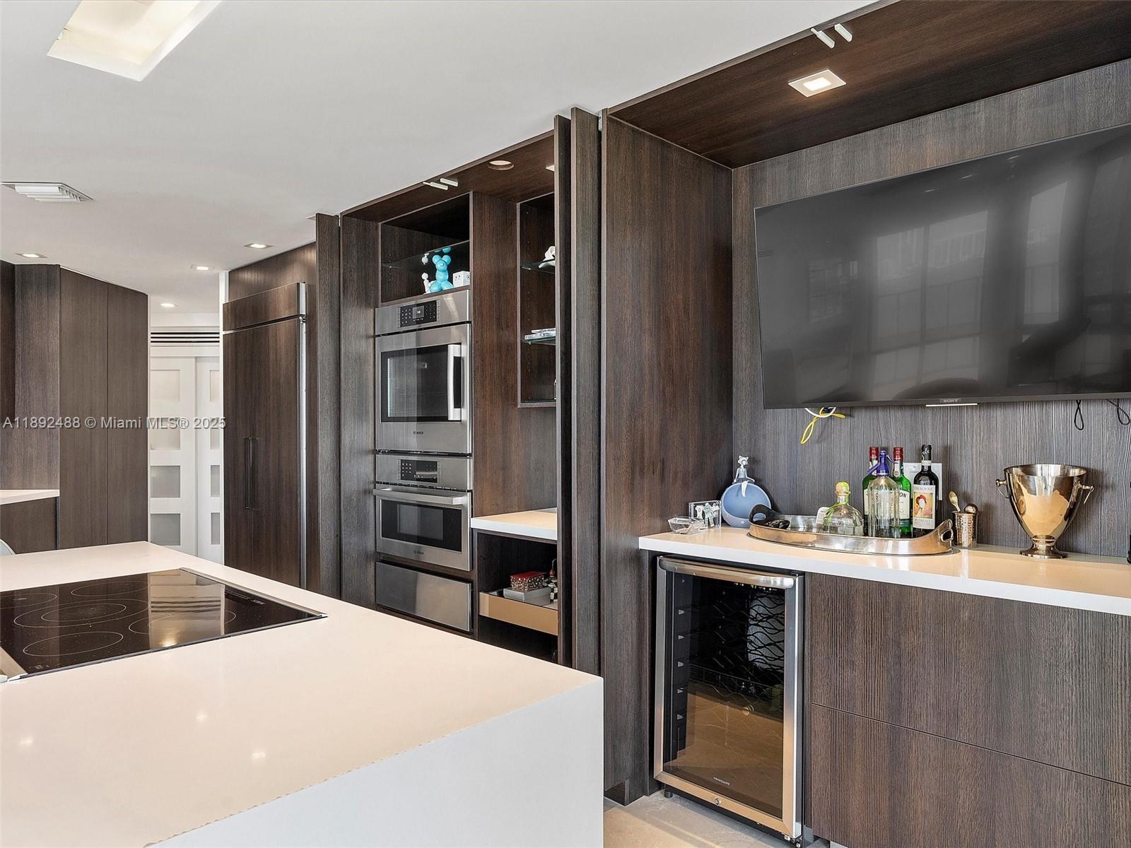 4000 Island Boulevard, Unit 606 Aventura, FL 33160 - Photo 19 of 36 a kitchen with a refrigerator and a sink