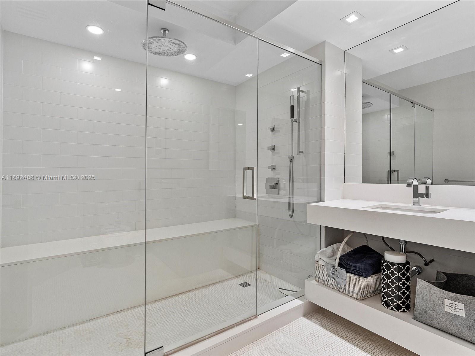 4000 Island Boulevard, Unit 606 Aventura, FL 33160 - Photo 20 of 36 a bathroom with a sink a toilet a mirror and shower