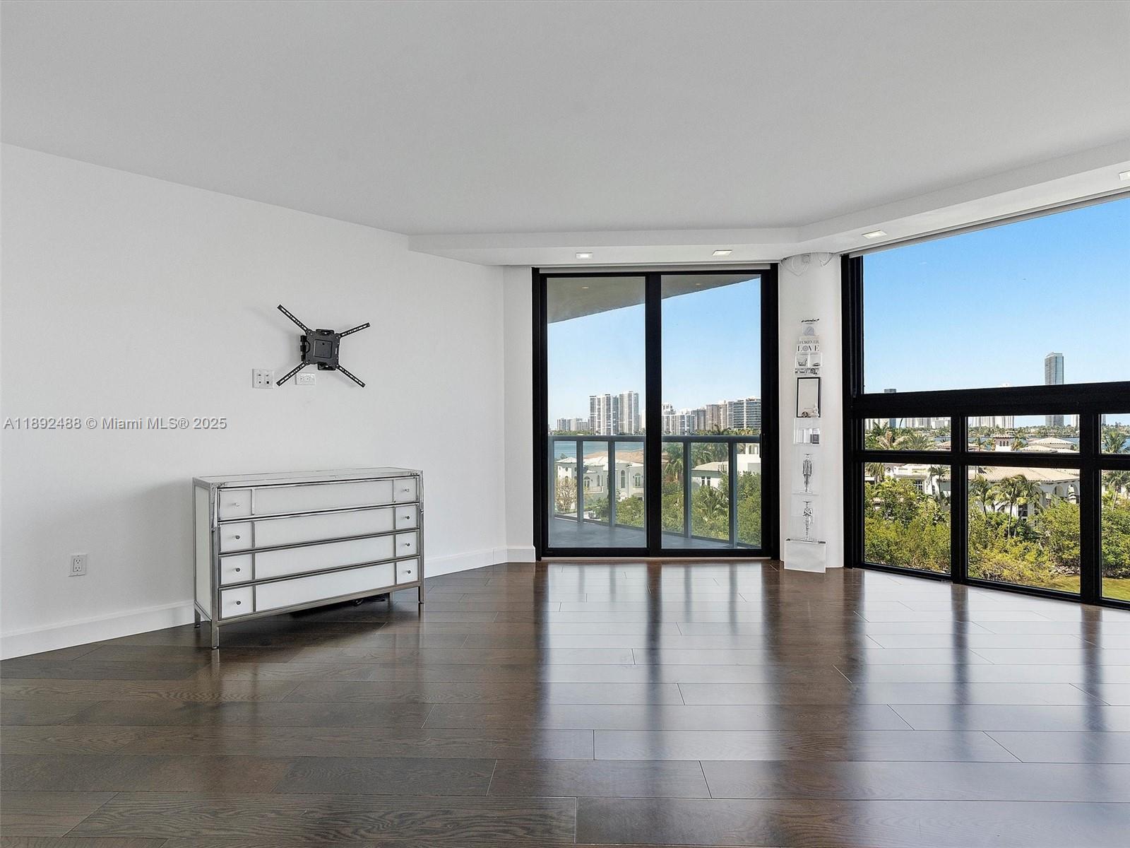 4000 Island Boulevard, Unit 606 Aventura, FL 33160 - Photo 25 of 36 wooden floor in an empty room with a window