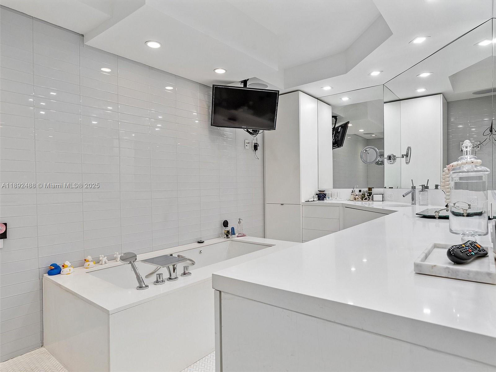 4000 Island Boulevard, Unit 606 Aventura, FL 33160 - Photo 26 of 36 a bathroom with a sink and a mirror