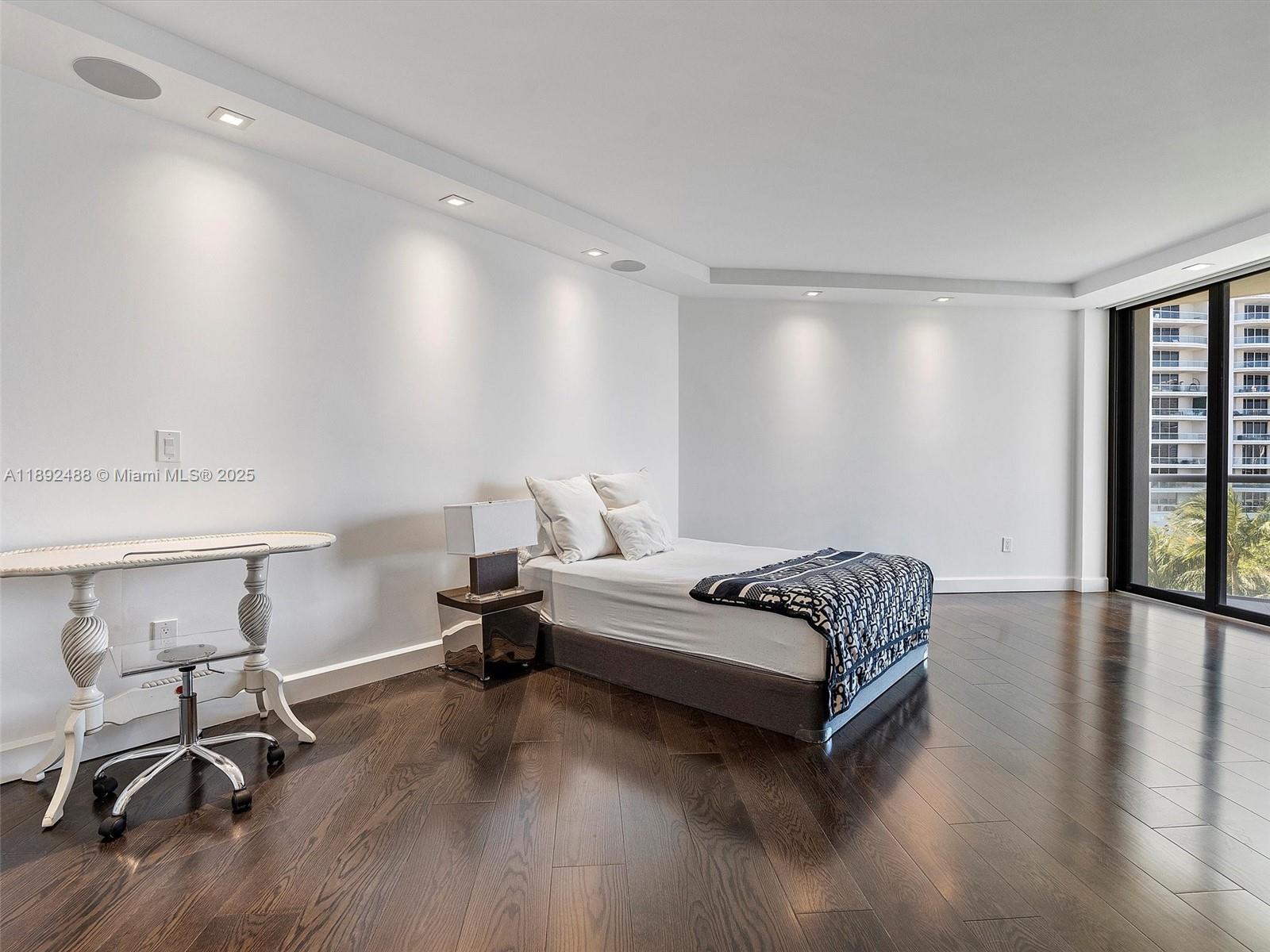 4000 Island Boulevard, Unit 606 Aventura, FL 33160 - Photo 29 of 36 a spacious bedroom with a bed and a chair