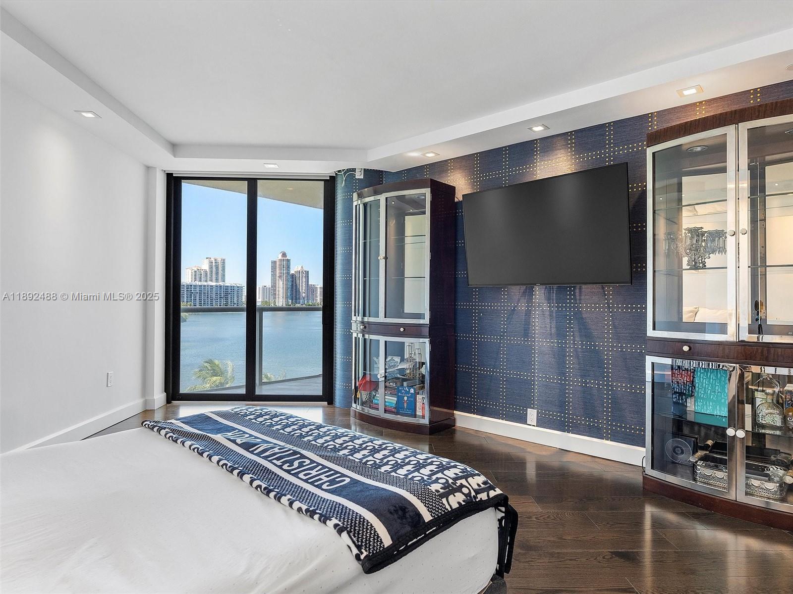 4000 Island Boulevard, Unit 606 Aventura, FL 33160 - Photo 31 of 36 a bedroom with a large bed and a tv