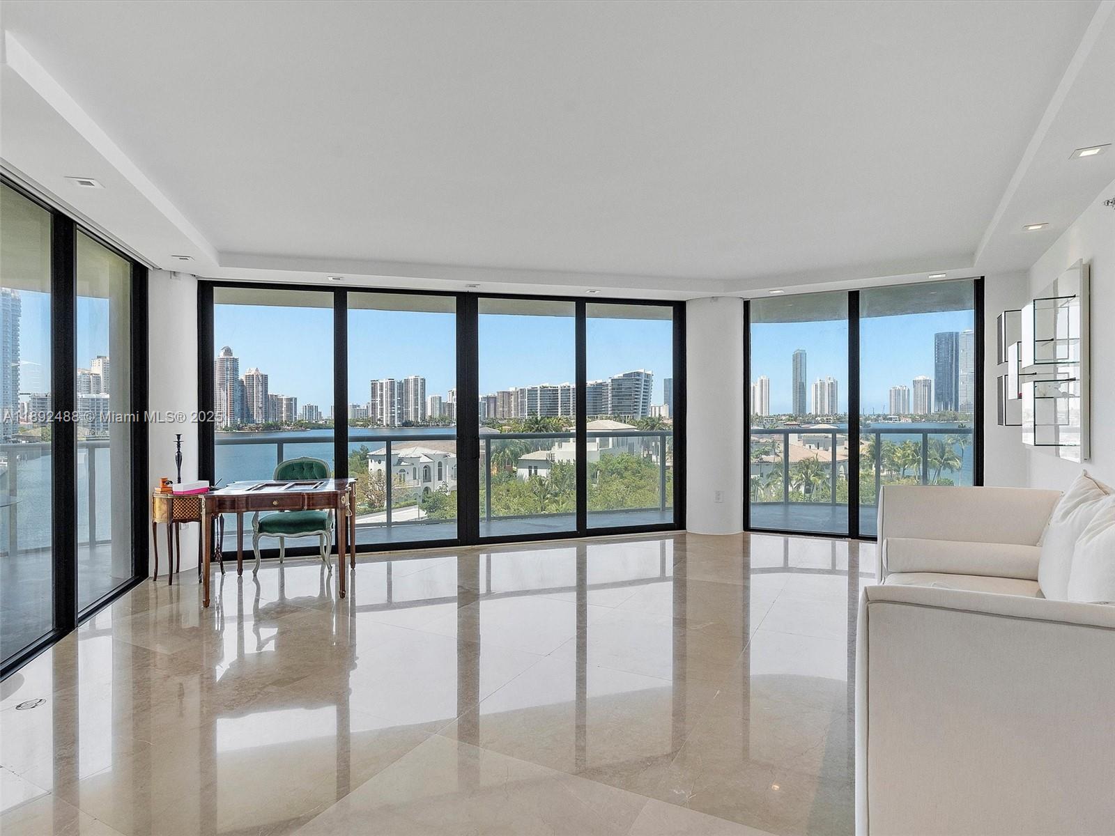4000 Island Boulevard, Unit 606 Aventura, FL 33160 - Photo 5 of 36 a living room with furniture and floor to ceiling windows