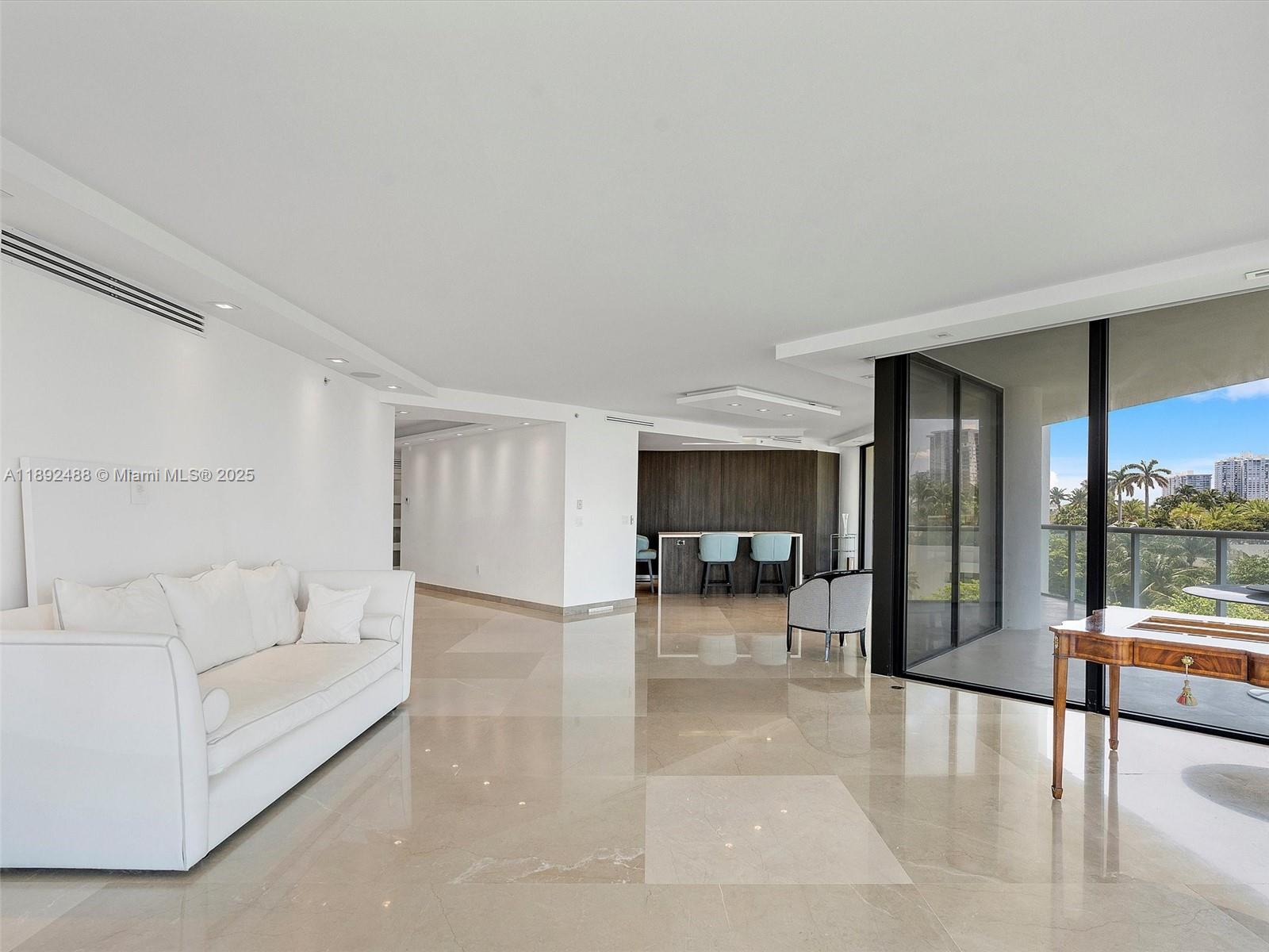 4000 Island Boulevard, Unit 606 Aventura, FL 33160 - Photo 8 of 36 a living room with furniture and a table