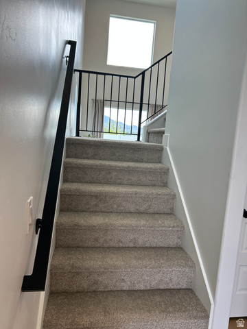 2011 West 1150 South, Unit 1042 Payson, UT 84651 - Photo 25 of 39 Photos are of model home.Carpeted staircase with contemporary black metal railing and handrail