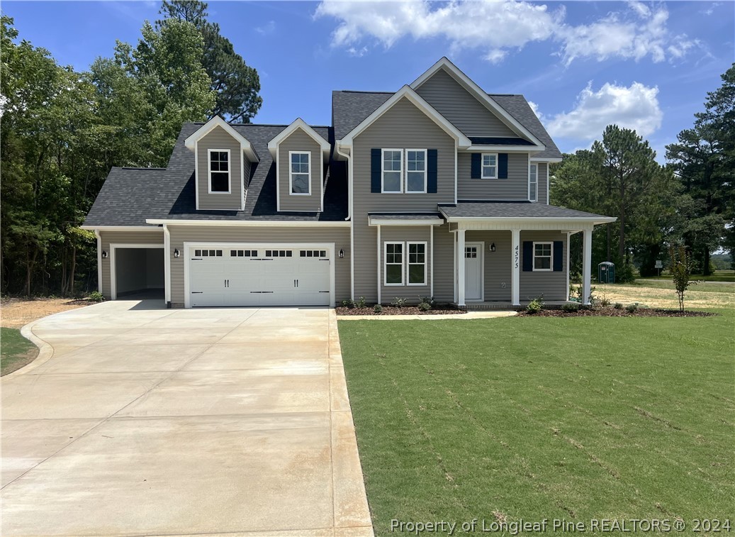 4575 Niagara Carthage Road Carthage, NC 28327 - Photo 1 of 32 a front view of a house with a garden