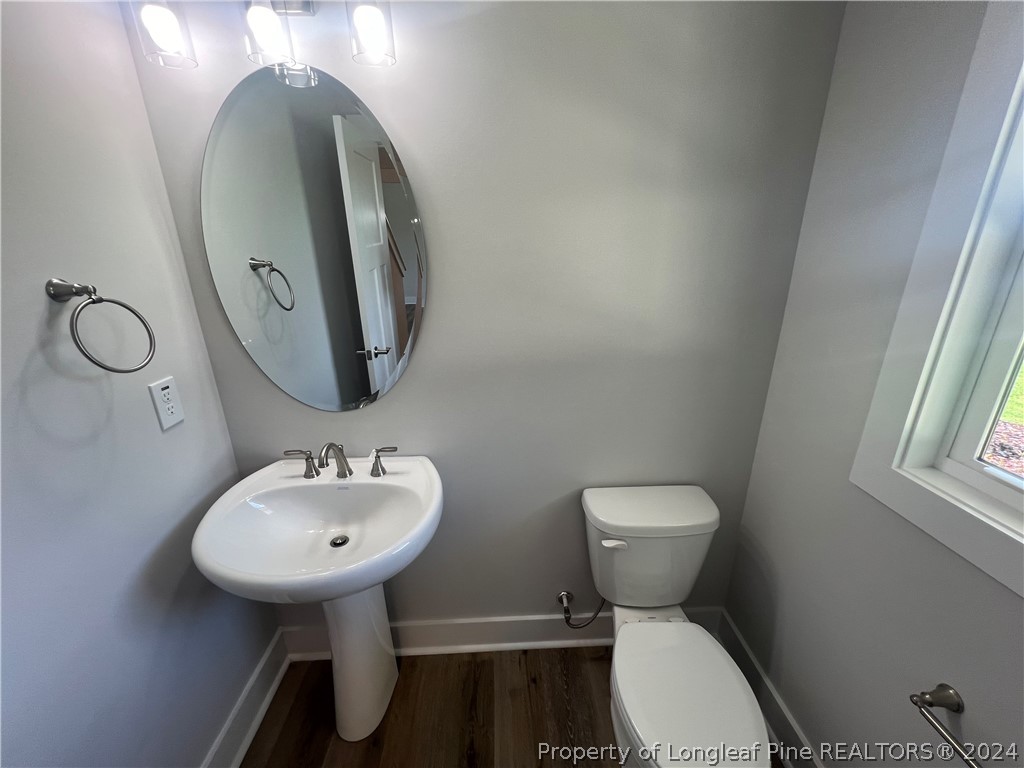 4575 Niagara Carthage Road Carthage, NC 28327 - Photo 4 of 32 a bathroom with a toilet sink and mirror