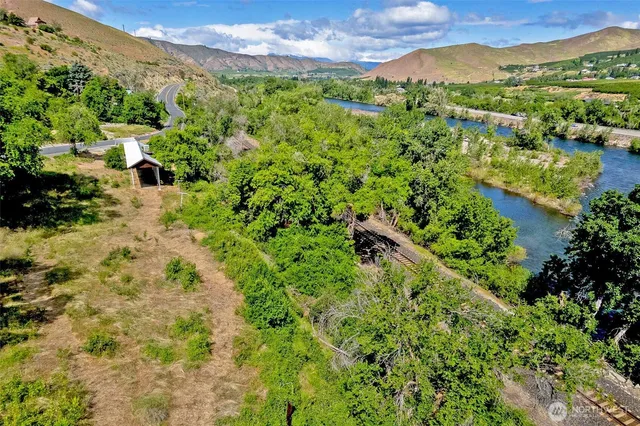 a view of a lush green hillside and houses