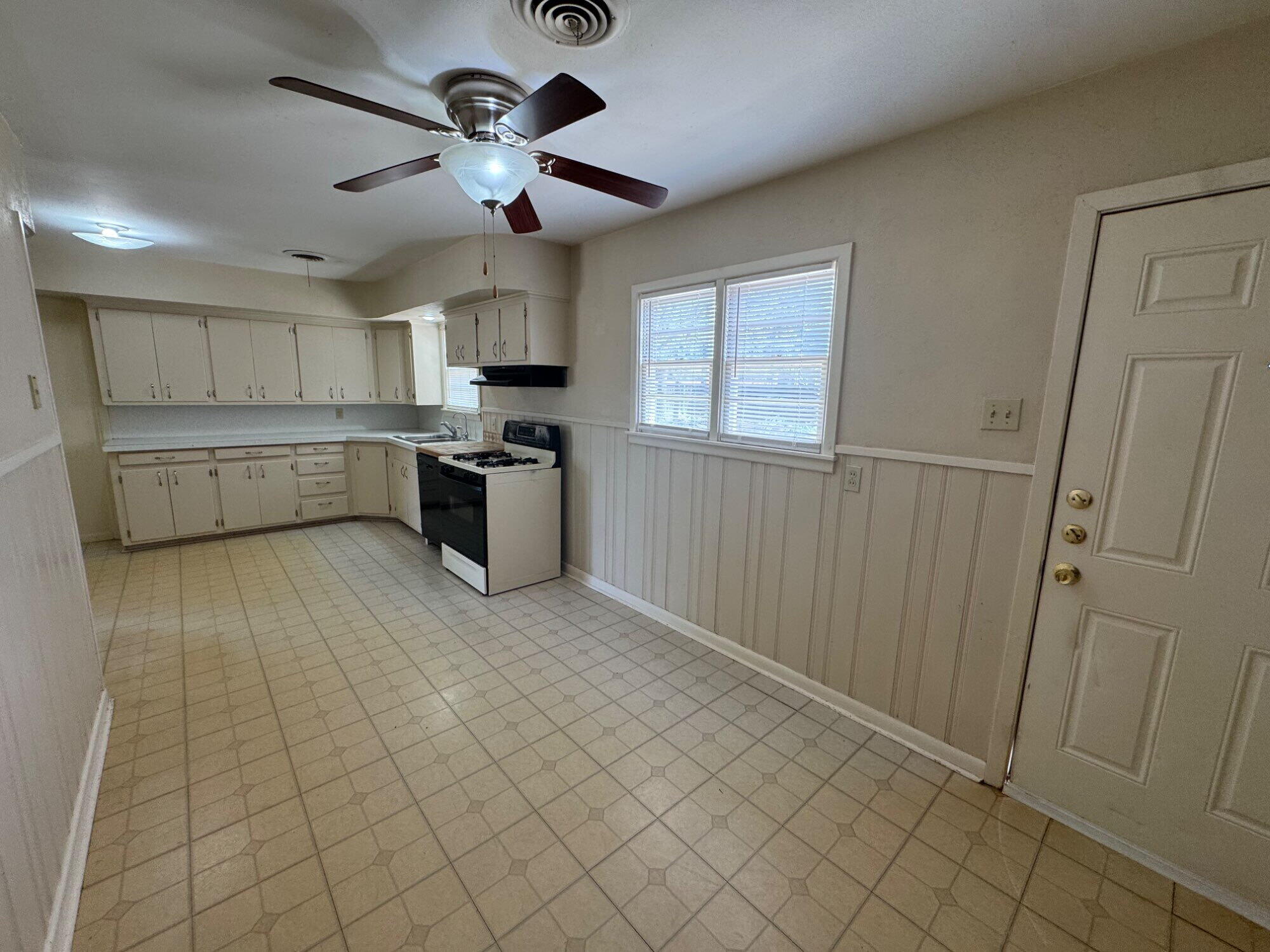 3605 40th Street Lubbock, TX 79413 - Photo 5 of 11 a kitchen with cabinets and window
