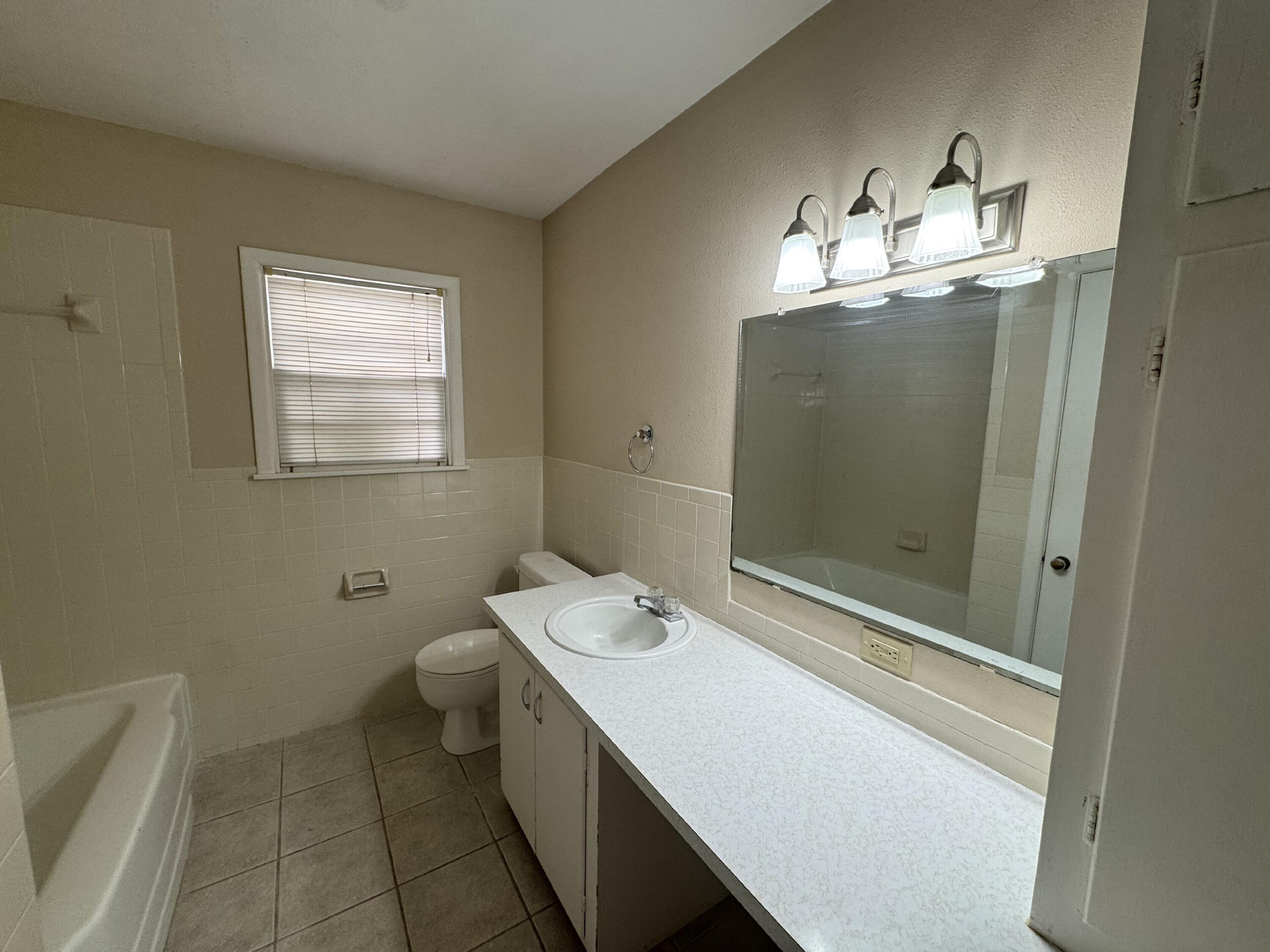 3605 40th Street Lubbock, TX 79413 - Photo 7 of 11 a bathroom with a sink a toilet and shower