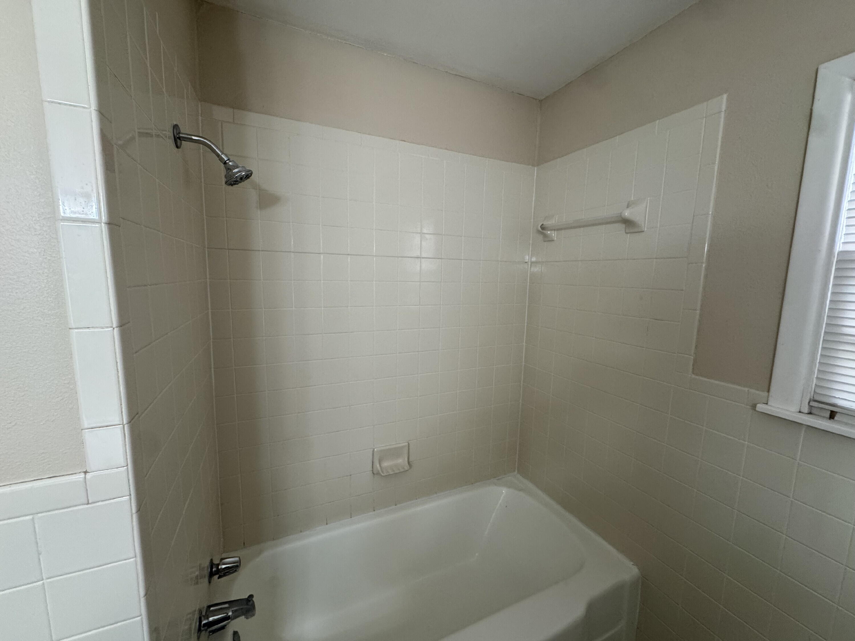 3605 40th Street Lubbock, TX 79413 - Photo 8 of 11 a bathroom with a bathtub