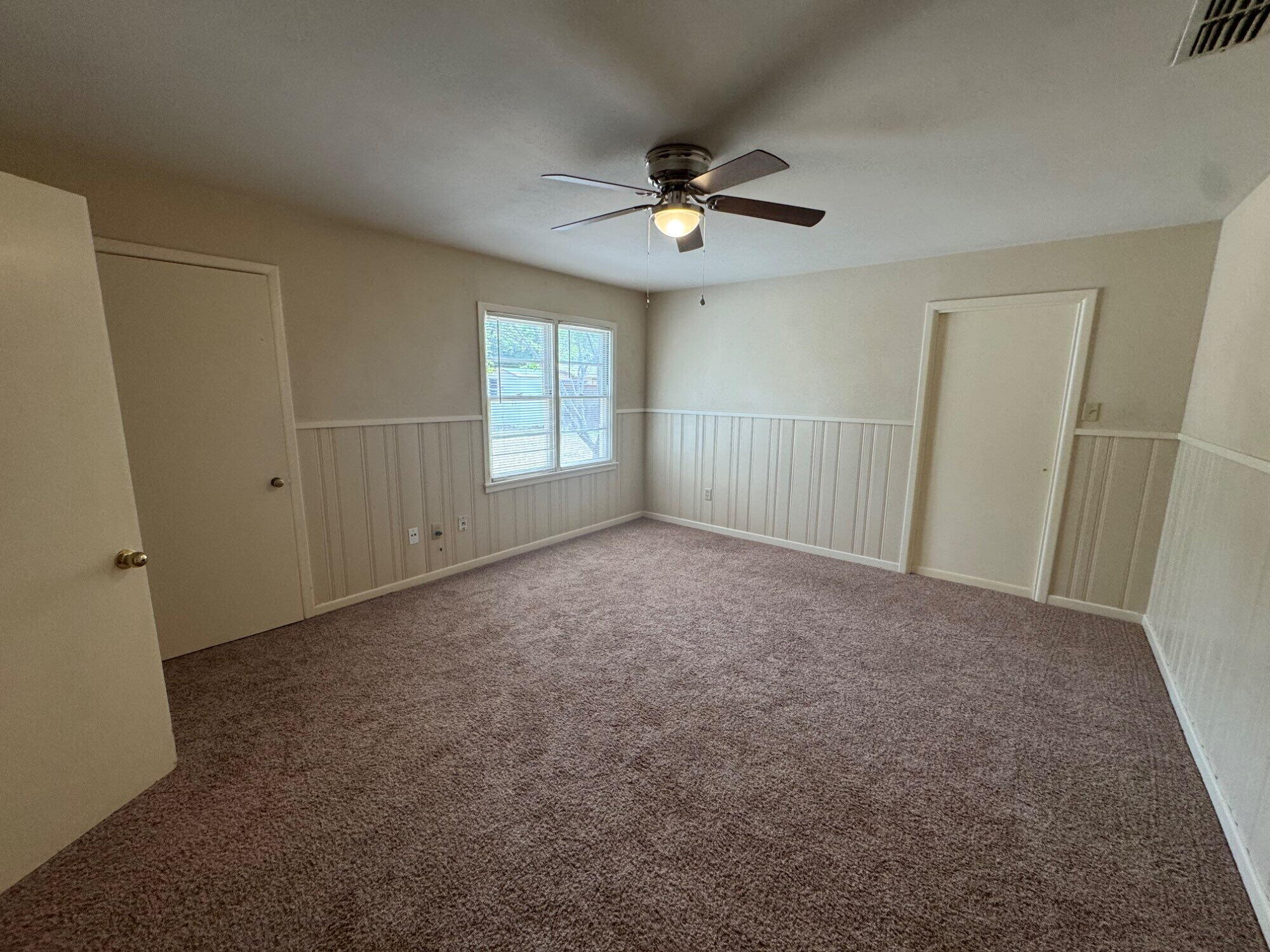 3605 40th Street Lubbock, TX 79413 - Photo 9 of 11 a view of a livingroom with a ceiling fan and window