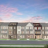 a front view of a residential apartment building with a yard