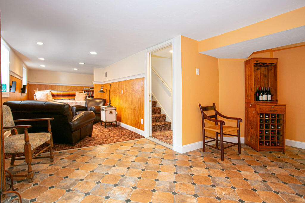 5 Scraggy Neck Rd Extension Bourne, MA 02534 - Photo 14 of 37 a living room with furniture a flat screen tv and chairs