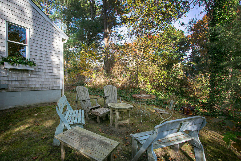 5 Scraggy Neck Rd Extension Bourne, MA 02534 - Photo 23 of 37 a view of a patio with table and chairs and potted plants