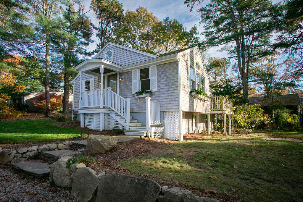 5 Scraggy Neck Rd Extension Bourne, MA 02534 - Photo 25 of 37 a front view of a house with a garden