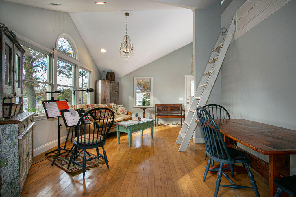 5 Scraggy Neck Rd Extension Bourne, MA 02534 - Photo 6 of 37 a dining room with furniture a chandelier and wooden floor