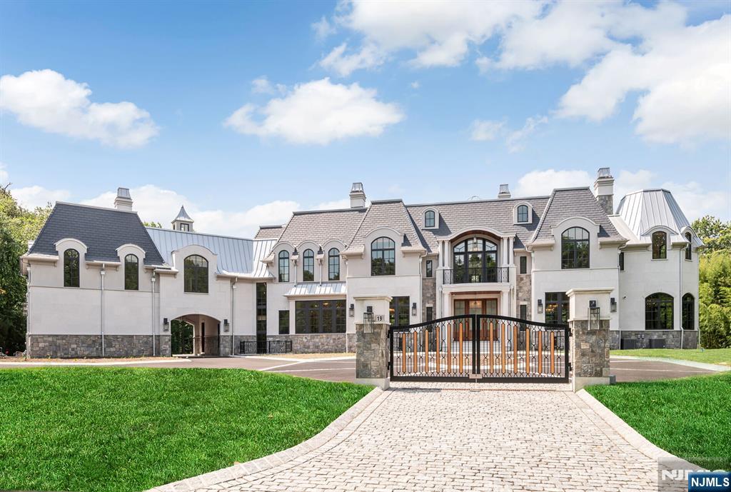 19 Rio Vista Drive Alpine, NJ 07620 - Photo 1 of 49 a front view of a house with a yard