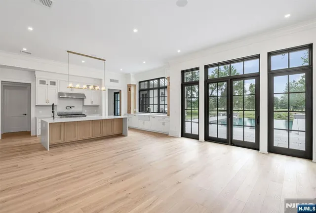 a spacious bathroom with a large tub and large windows